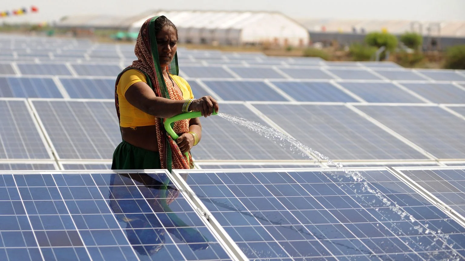 سيدة أمام ألواح شمسية في الهند